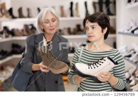 Two women are shopping in shoe store 129456789