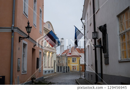 Narrow cobblestone street with Estonian flags in Tallinn old town Narrow cobblestone street with Estonian flags in Tallinn old town 129456945
