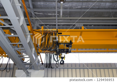 Overhead crane or lifting equipment inside factory or warehouse. Overhead crane or lifting equipment inside factory or warehouse. 129456953