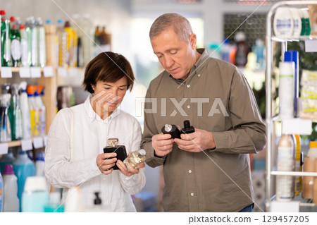 Couple man and woman choosing perfume in store Couple man and woman choosing perfume in store 129457205