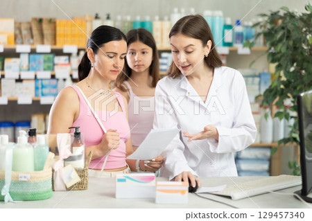 Pharmacist looking for prescription for mother and daughter buyers Pharmacist looking for prescription for mother and daughter buyers 129457340