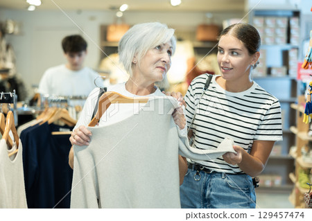 Ladies carefully select sweaters 129457474