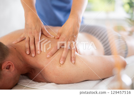 the client lies while the worker gives a massage 129457516
