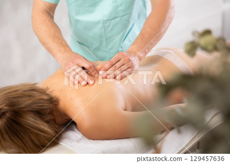 the client lies while the worker gives a massage 129457636