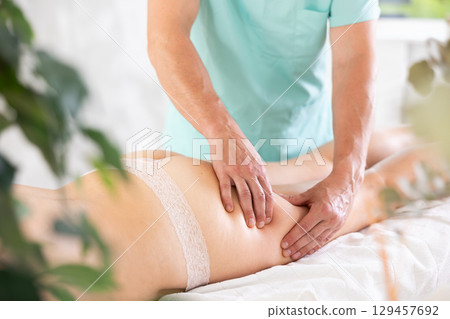 the client lies while the worker gives a massage 129457692