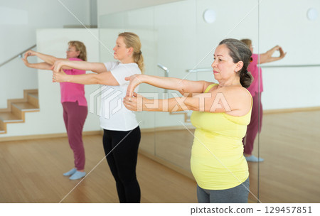 Mature women warming up before dance training 129457851