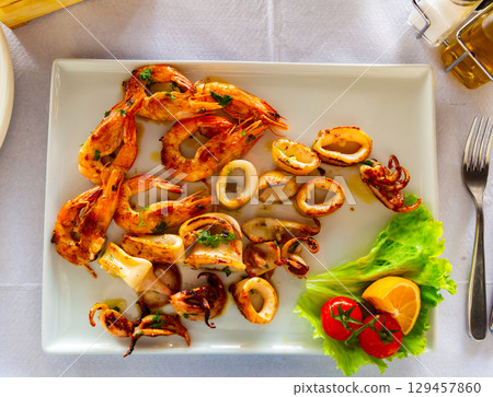 Fried shrimp, octopus and other seafood on plate Fried shrimp, octopus and other seafood on plate 129457860
