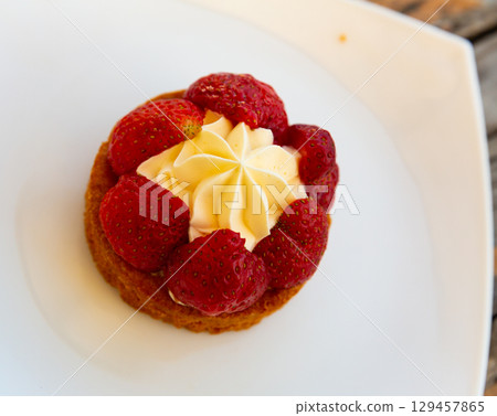 Strawberry dessert with cream on white plate Strawberry dessert with cream on white plate 129457865