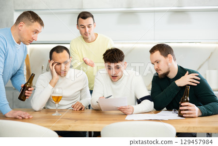 Friends consoling upset worried man reading unexpected medical results Friends consoling upset worried man reading unexpected medical results 129457984