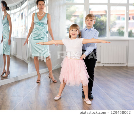 Boy and girl in pair train to dance contemporary vigorous waltz during classes. Boy and girl in pair train to dance contemporary vigorous waltz during classes. 129458062