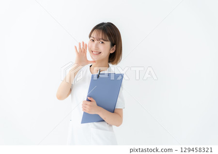 Female nurse in white coat, medical record, cheering 129458321