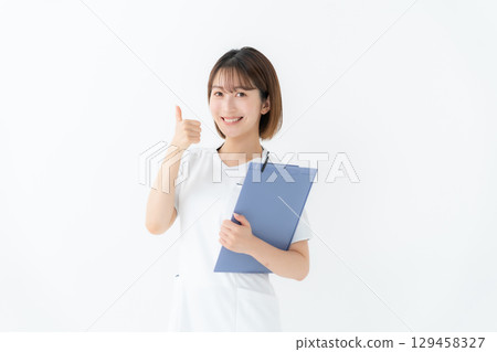 Female white coat nurse medical chart thumbs up Female white coat nurse medical chart thumbs up 129458327