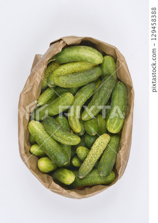 Paper bag filled with pickling cucumbers 129458388