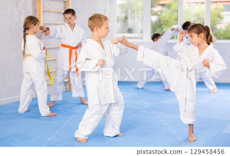 Karate students engage in sparring 129458456