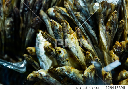 Cured herring and other fish in supermarket 129458896