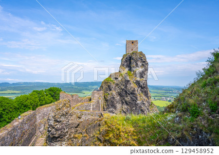 Trosky Castle ruins rise majestically atop a rocky outcrop in Bohemian Paradise, Czechia. The structure offers stunning views of the surrounding lush landscape and historical significance. Trosky Castle ruins rise majestically atop a rocky outcrop in Bohemian Paradise, Czechia. The structure offers stunning views of the surrounding lush landscape and historical significance. 129458952