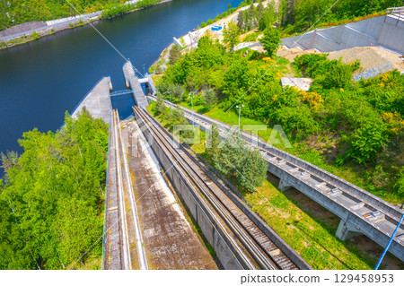 Overlooking the boat lift at Orlik Dam, this location in Czechia highlights its engineering marvel surrounded by lush greenery and tranquil water, showcasing the importance of waterway transport. 129458953