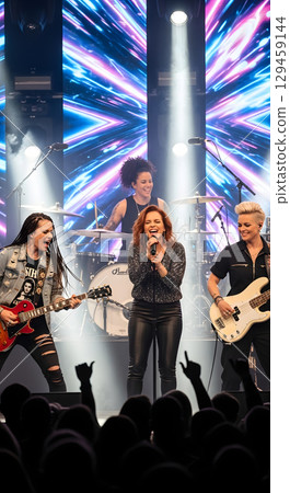 Girl band performing on stage 129459144