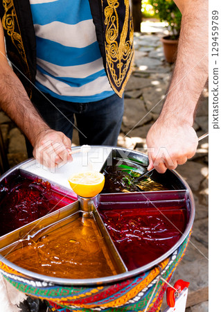 Colorful traditional Turkish street sweets vendor at work 129459789
