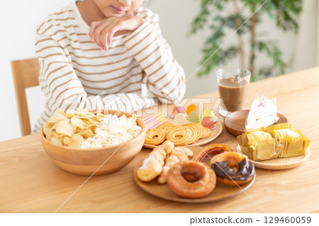 A middle school girl is troubled by the sight of so many sweets 129460059