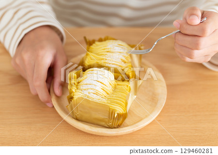 A middle school girl eating Mont Blanc cake in her room 129460281