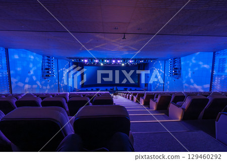 Spacious auditorium with blue lighting and theater setup Spacious auditorium with blue lighting and theater setup 129460292