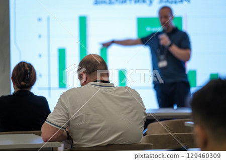 Speaker presenting data to attentive audience during business seminar Speaker presenting data to attentive audience during business seminar 129460309