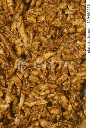 Grated smoked tofu in a soy and mustard marinade 129460858