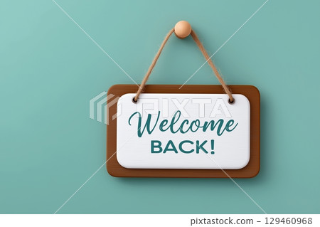 Photo of a "Welcome Back " sign hanging on a turquoise wall. 129460968