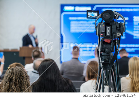 Professional conference recording with speaker and audience captured by video equipment Professional conference recording with speaker and audience captured by video equipment 129461154