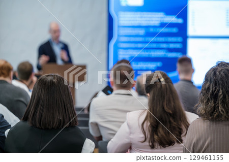 Audience listening to presentation in business conference setting Audience listening to presentation in business conference setting 129461155