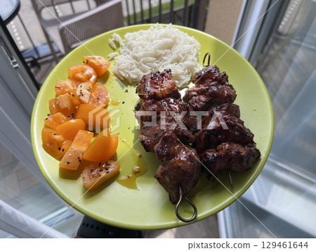 Floating White plate with Mixed meat grilled and salad on home background Floating White plate with Mixed meat grilled and salad on home background 129461644