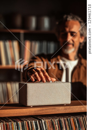 Man adjusting speaker knob 129461718