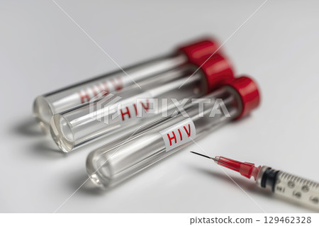 Medical equipment for health testing and disease diagnosis featuring syringe and vial with fluid sample. These important tools for healthcare and science evoke feelings of concern and hope 129462328