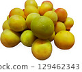 A large number of ripe plums are arranged on a white background. The plums are covered with water droplets. The plums are yellow, red, and yellow-green. 129462343
