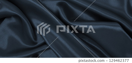 Smooth elegant dark grey silk or satin luxury cloth texture as abstract background. Luxurious background design Smooth elegant dark grey silk or satin luxury cloth texture as abstract background. Luxurious background design 129462377