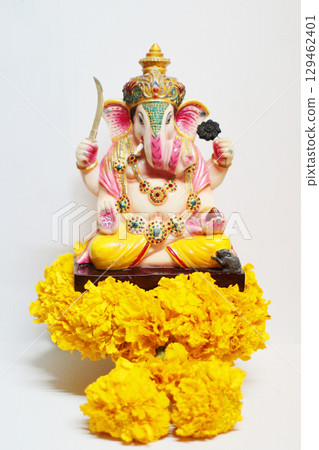 Ganesha god is the Lord of Success God of Hinduism on Marigold flowers Isolated on white background. Ganesha god is the Lord of Success God of Hinduism on Marigold flowers Isolated on white background. 129462401