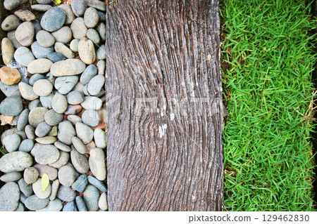 Texture Detail of gaden design with White gravel, old wood and grass decoration on the ground in garden. Texture Detail of gaden design with White gravel, old wood and grass decoration on the ground in garden. 129462830