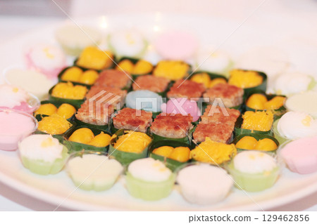 Traditional Thai sweet desserts.Sweet sticky rice with egg custard on top on banana leaves Traditional Thai sweet desserts.Sweet sticky rice with egg custard on top on banana leaves 129462856