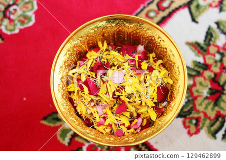 Red rose and Marigold flowers petals in gold tray in tradition Thai wedding ceremony and Buddhism in the temple Red rose and Marigold flowers petals in gold tray in tradition Thai wedding ceremony and Buddhism in the temple 129462899