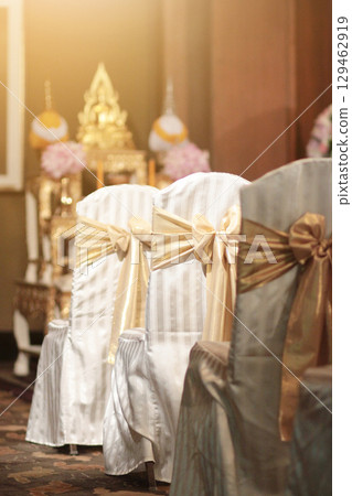 Beautiful chairs decoration with ribbon in wedding event hall, selective focus. Beautiful chairs decoration with ribbon in wedding event hall, selective focus. 129462919