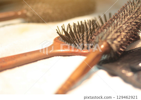 Wooden Comb with woman hair loss on the make up table in dressing room 129462921