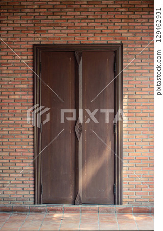 Sunshine through on Antique thai style wooden window on brick wall. Vintage concept. 129462931