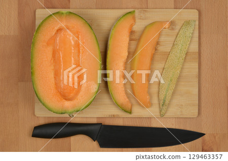 Cutting cantaloupe melon Cutting cantaloupe melon 129463357