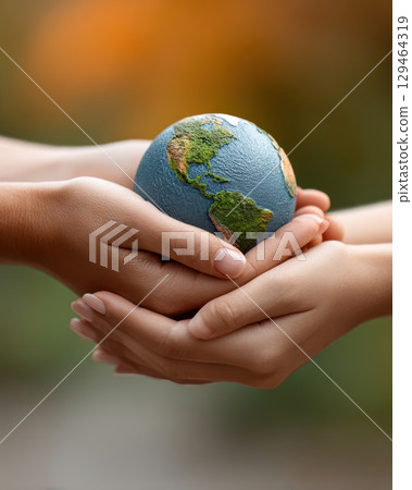 Closeup Of Hands Caring For Miniature Green And Brown Globe, Fostering Environmental Awareness Protection 129464319