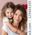 Mother Daughter Embrace Warm Light, Pink Backdrop, Brown Hair, White Shirt, Heart, Knit 129464395