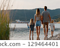 Peaceful Family Outing Warm Day By The Lake With Father, Mother, And Kids Under A Clear Sky 129464401