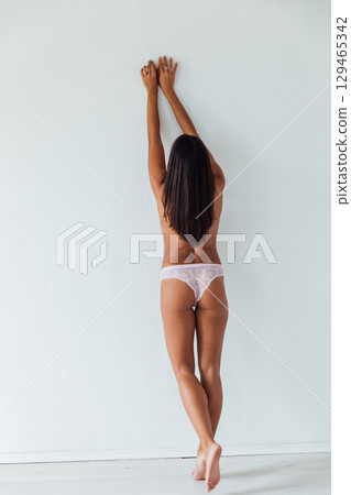 brunette in light lingerie on white background brunette in light lingerie on white background 129465342