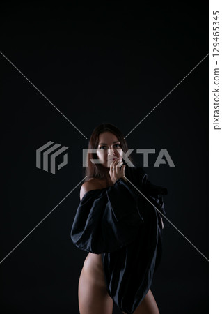 brunette woman in black lingerie on dark background brunette woman in black lingerie on dark background 129465345