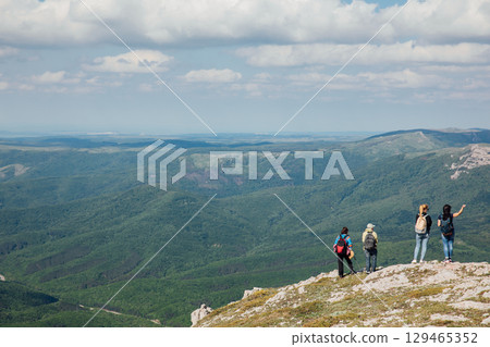 Tourists look at the landscape, mountains and forest Tourists look at the landscape, mountains and forest 129465352
